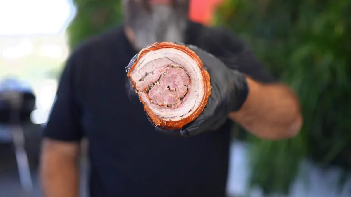 Ready to serve. Cooked porchetta slice held by Adriano, from his Gringo recipe video