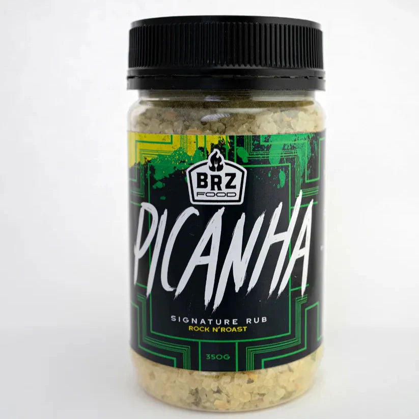 BRZ Food Picanha Seasoning displayed with grilled steak and open flames representing bold flavour and authentic churrasco cooking.
